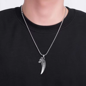 Silver wolf head pendant necklace in stainless steel with pearl chain for men on black shirt