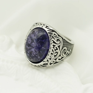 Retro Viking rune ring with engraved baroque patterns and a large oval purple gemstone