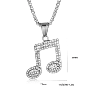 Detail of silver musical note pendant with sparkling rhinestones and dimensions 34x29mm