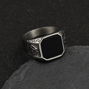 Detail of vintage Viking steel ring with rectangular black stone on black slate