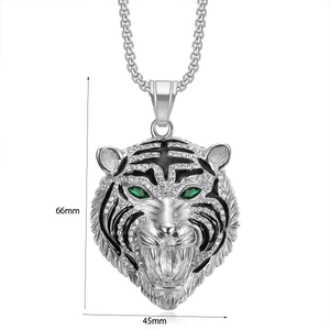 Detail view of crystal tiger head pendant measuring 66mm by 45mm with green gem eyes