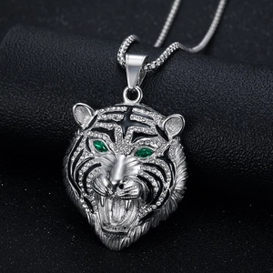 Iced out tiger head pendant necklace in silver with green gemstone eyes and box chain