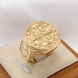 Detailed relief of Saint Benedict Medal and cross symbols on golden stainless steel ring