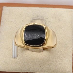Top down detail of square black enamel inlay on wide gold finish stainless steel ring