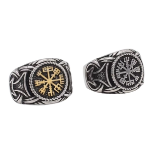 Detail of vintage Viking rings featuring Vegvisir compass and runes in silver and gold