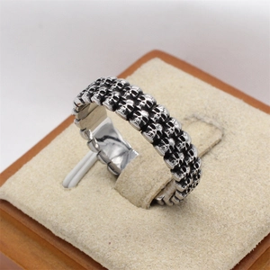 Retro punk style stainless steel ring featuring double-row skull carvings for men