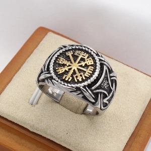 Macro detail of men's Viking Vegvisir ring with silver base and gold compass inlay
