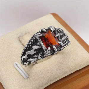 Gothic dragon claw ring with a large rectangular orange red gemstone in vintage silver