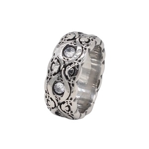Detailed view of silver vintage ring with intricate vine carvings and double crystal inlays