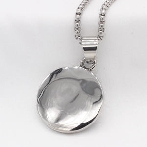 Polished silver eagle round pendant necklace with box chain for men on white fabric