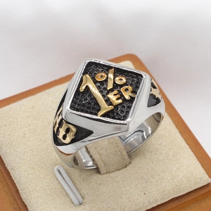 Macro detail of retro men's steel ring with golden 1%ER emblem and 13 engraving