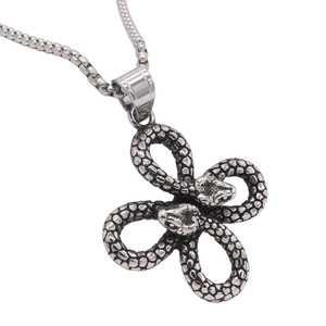 Vintage stainless steel double snake cross pendant necklace with textured scales on white back