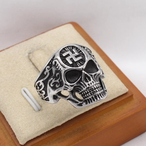 Retro stainless steel skull ring with swastika symbol and ornate side carvings