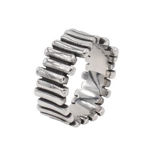 Detailed close-up of retro silver stainless steel ring with vertical textured stripe design