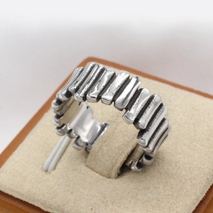 Close-up of vintage stackable silver titanium ring with industrial vertical grooves