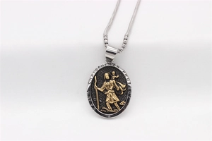 Detail of Saint Christopher gold relief pendant with Saint Christopher Protect Us engraving