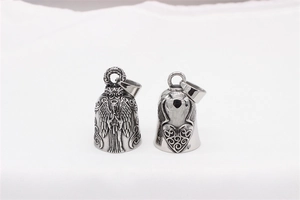 Detailed view of silver guardian bell pendants with angel and heart relief patterns