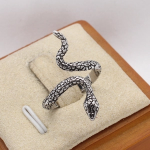 Macro shot of vintage snake ring showing detailed scale textures and curves
