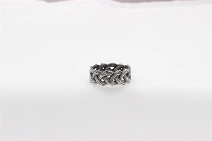 Macro shot of vintage silver Celtic knot weave pattern on the stainless steel ring