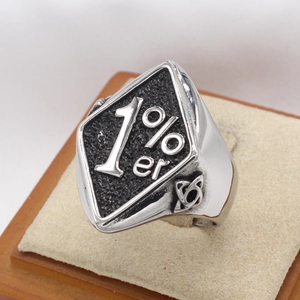 Macro shot of 1%er engraved signet ring with black textured inlay on display stand