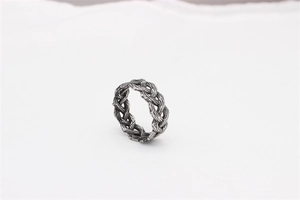 Detailed macro view of vintage braided stainless steel ring with oxidized finish for men