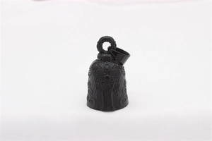 Macro view of vintage black angel bell pendant with detailed relief and matte finish