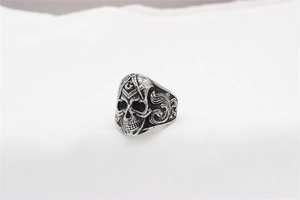 Macro shot of retro stainless steel masonic skull ring with engraved masonry symbol
