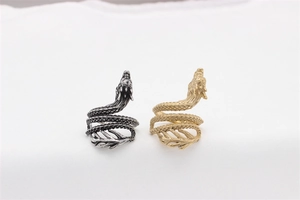 Detailed view of vintage dragon wrap rings in gold and antique silver steel finishes