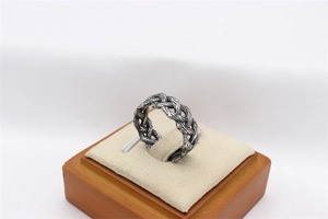 Detailed view of vintage woven Viking Celtic pattern on silver stainless steel ring