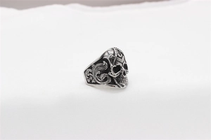 Detailed macro view of vintage silver skull ring featuring Freemasonry square and compass