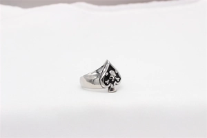 Detailed close-up of punk spade skull ring in polished stainless steel with black enamel