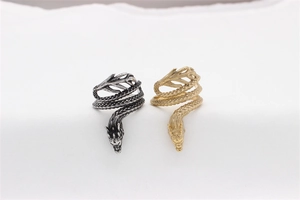 Close-up of vintage dragon scale rings in antique black and gold plated finishes