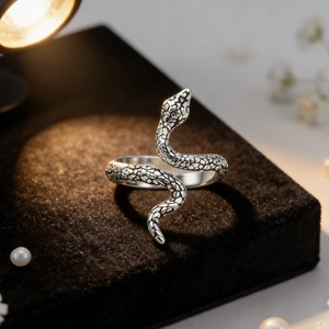 Retro stainless steel snake ring with detailed scale textures on black velvet