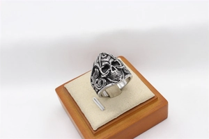 Detailed macro view of Masonic skull ring in vintage stainless steel on wood display