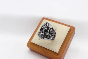 Macro view of vintage silver skull ring with Freemason symbol and baroque engravings