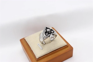 Detailed view of punk spade ring with skull and crossbones motif in vintage steel