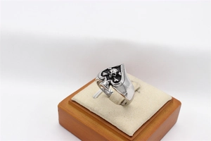 Detailed view of punk spade skull ring in retro steel finish on a display stand