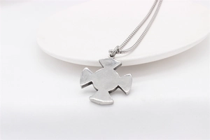 Close-up of vintage silver viking cross pendant on a dense snake bone chain
