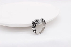 Macro detail of gothic dragon claw ring showing intricate scale textures in silver steel