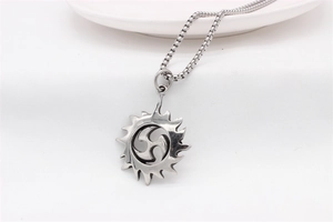 Detail of vintage sun pendant necklace with mitsudomoe pattern and durable box chain