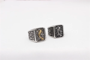 Close-up of retro koi carp signet rings with floral patterns and oxidized finish