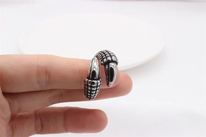 Macro detail of vintage punk claw ring showing grid texture and polished steel finish