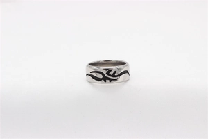 Detailed view of silver stainless steel ring featuring black tribal totem engraving