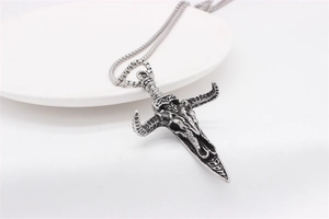 Detail of vintage bull skull pendant in antique silver finish with sturdy box chain