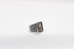Detailed close-up of retro koi fish relief with gold plating on vintage steel ring
