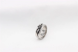 Macro detail of gothic tribal totem engraving on polished stainless steel ring band