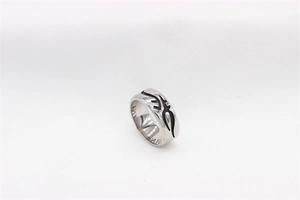 Detailed macro view of retro gothic totem patterns engraved on a men's titanium steel ring