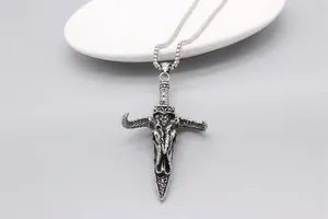 Macro shot of vintage silver bull skull dagger pendant with detailed gothic texture