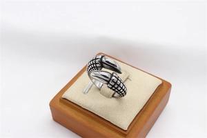 Detail of retro dragon claw steel ring showing detailed scales and polished sharp tips