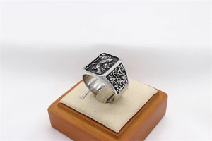 Macro shot of retro stainless steel koi fish ring with detailed relief and antique finish